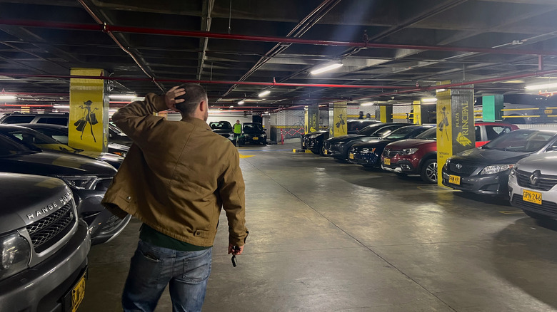 Man scratching the back of his head looking for his car