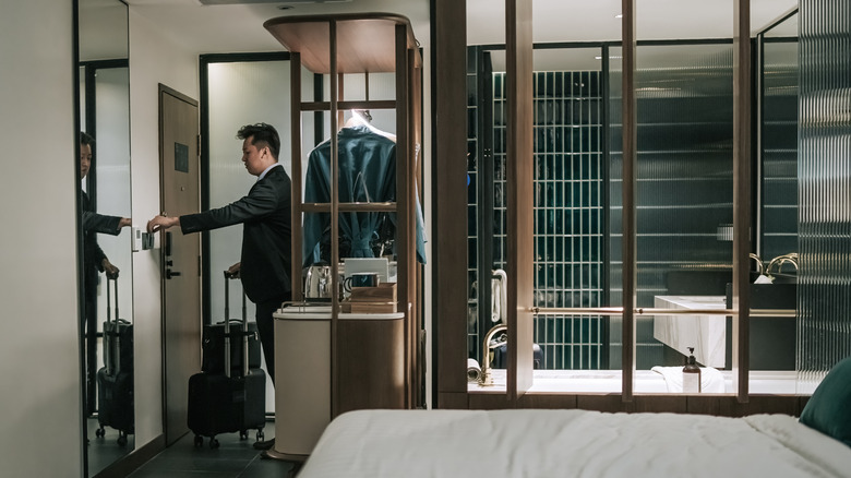 man leaving hotel room