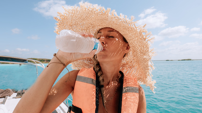 woman drinking water on boat