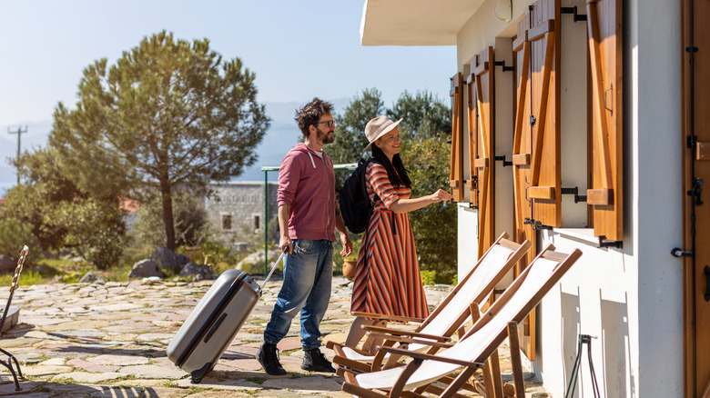 couple arriving at holiday home