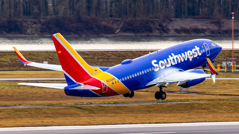A Southwest airplane taking off from a runway.
