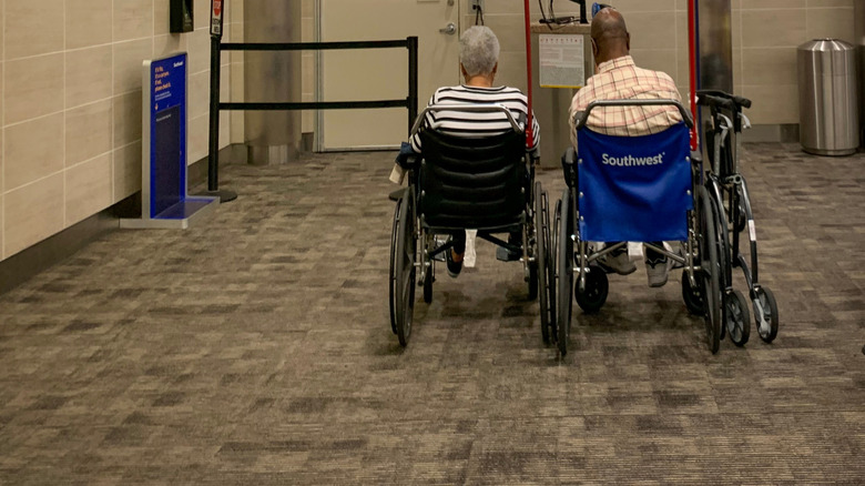 Two passengers in wheelchairs waiting to board a Southwest flight.