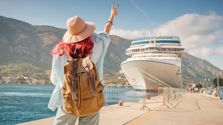 Passenger waving at cruise ship