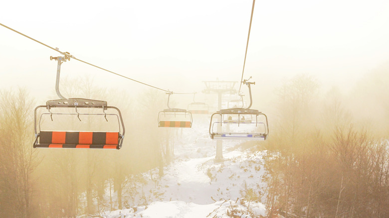 Empty chair lifts on a snowy mountain