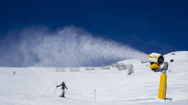 A snow gun produces snow on a mountain
