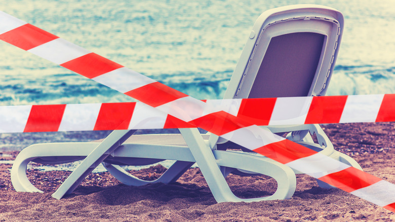Caution tape across beach chair