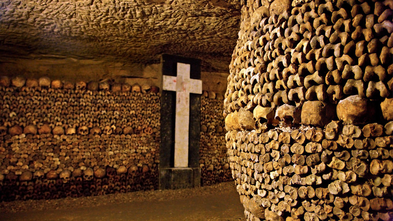 skulls and cross in catacombs