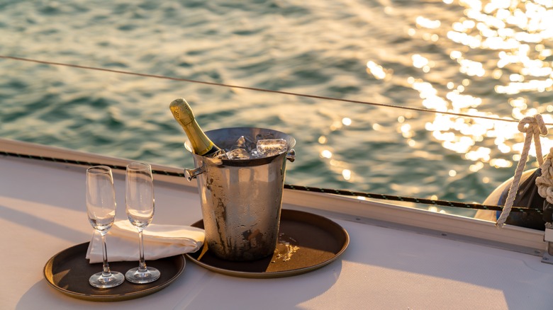 Champagne bucket with two glasses on trays on a ship