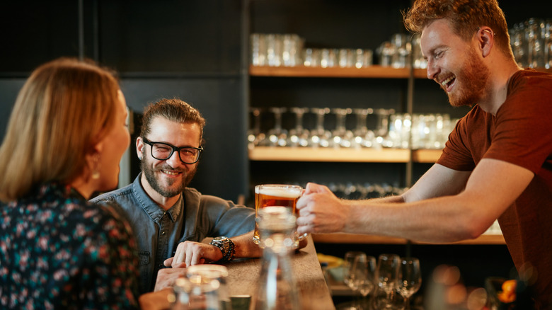 Bartender smiling with customers