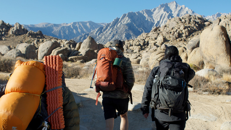 hikers approach Mount Whitney summit blue sky