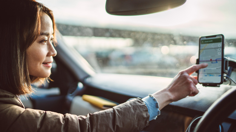 A woman uses a phone mount for her GPS app