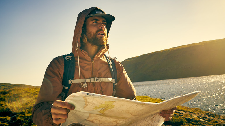 male hiker looking at map