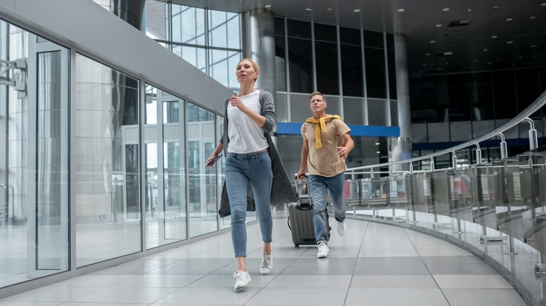 Passengers running through terminal