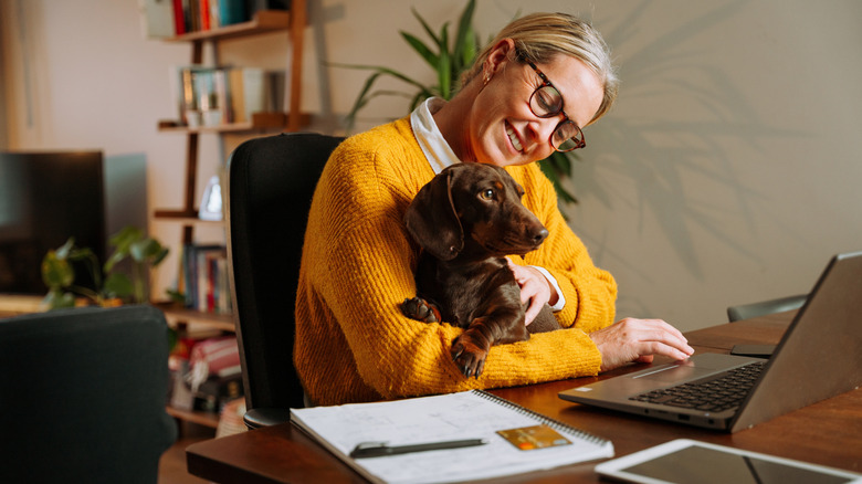 woman on computer with dog