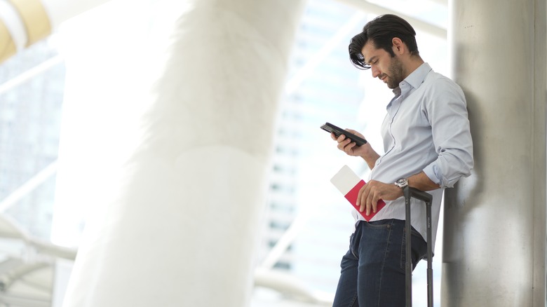 man looking at flight reservation