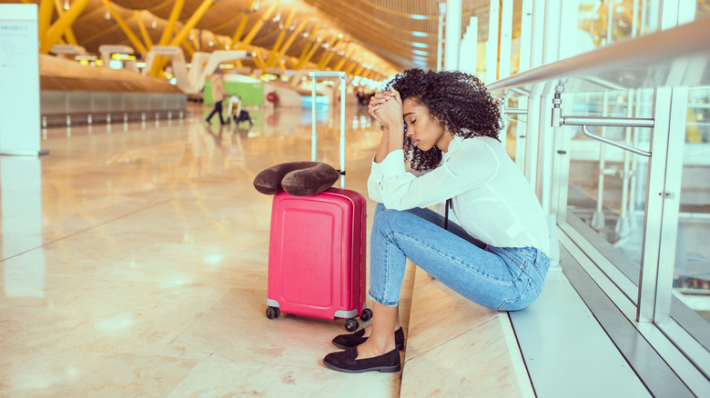 Woman sitting unhappy at airport