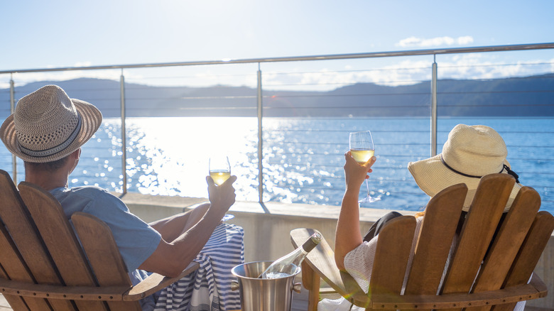 Couple sitting cruise ship deck wine