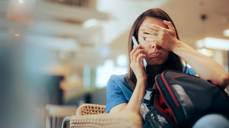 A stressed traveler on the phone