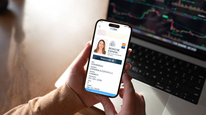 Spanish woman holds phone showing digital mobile ID