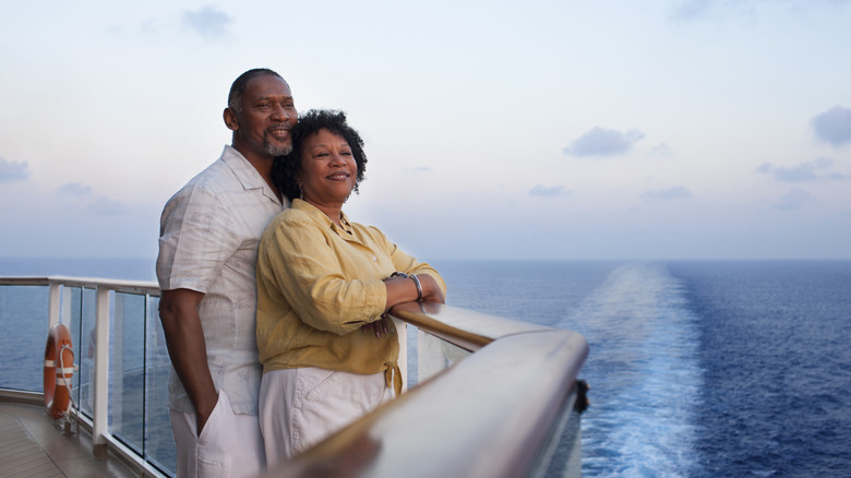 A couple looking out to sea on a cruise ship