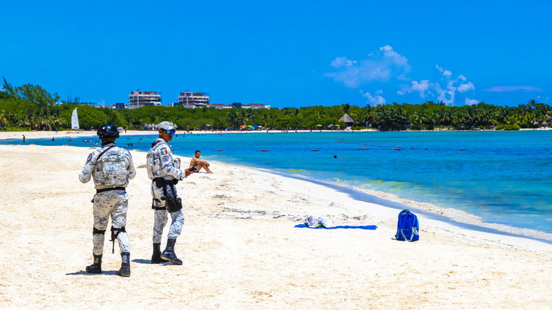 Two marines patrol a beach in Playa del Carmen, Mexico