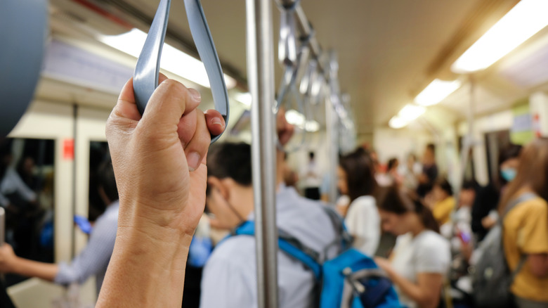 A hand holding a train car handle