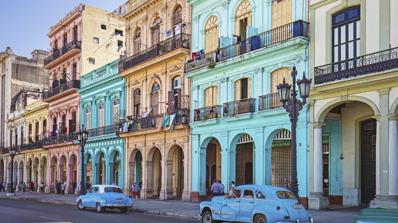 vintage cars outside colorful buildings Havana
