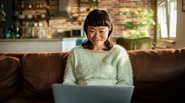 A woman using her computer at home
