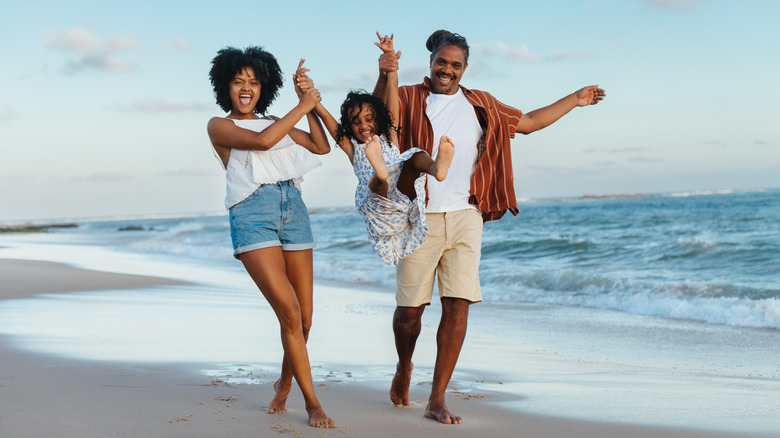 A happy family walking on the beach on vacation