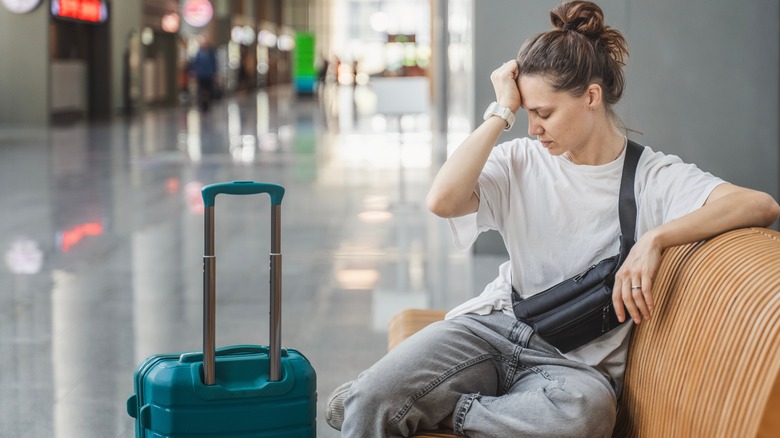 A woman is stressed and tired at the airport