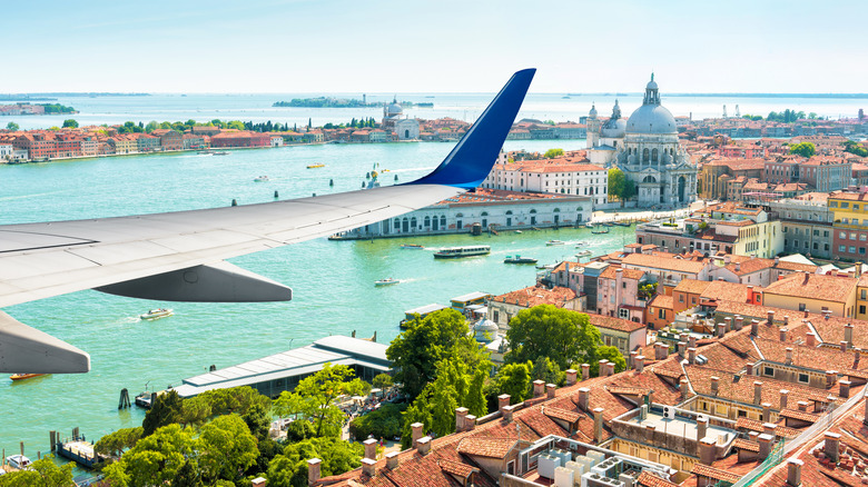 A plane flies over Venice