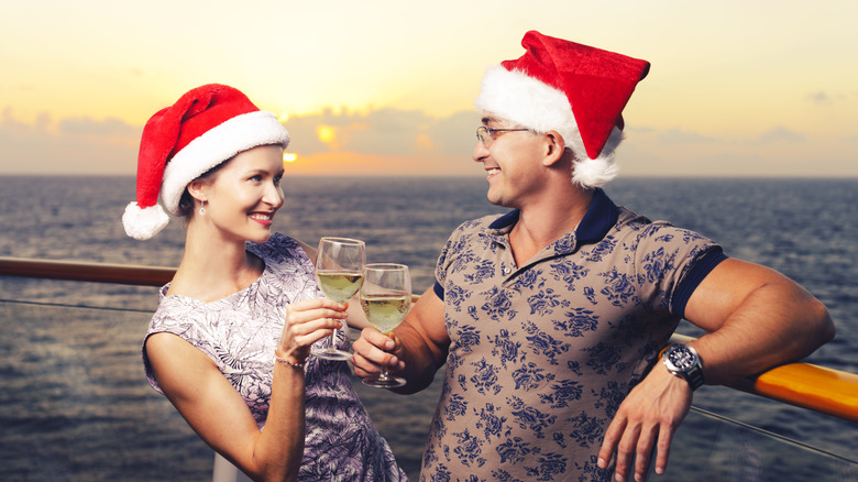 Couple on a cruise ship in Santa hats 