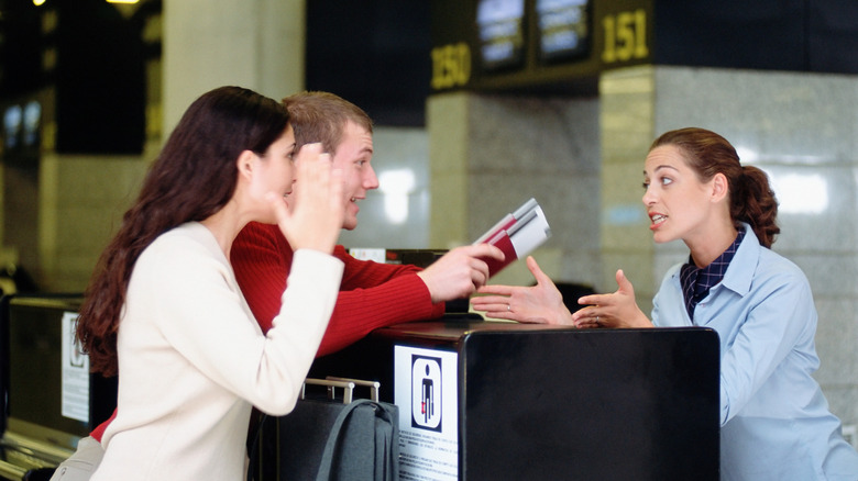 Couple arguing with gate agent