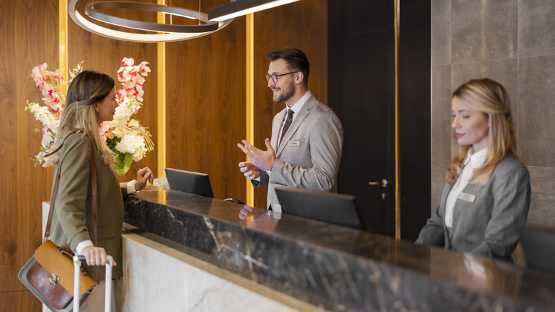 woman standing at hotel desk