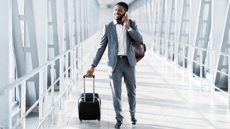 Businessman walking through airport  