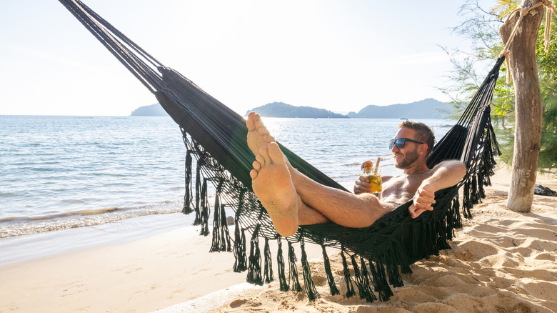 man in hammock on beach