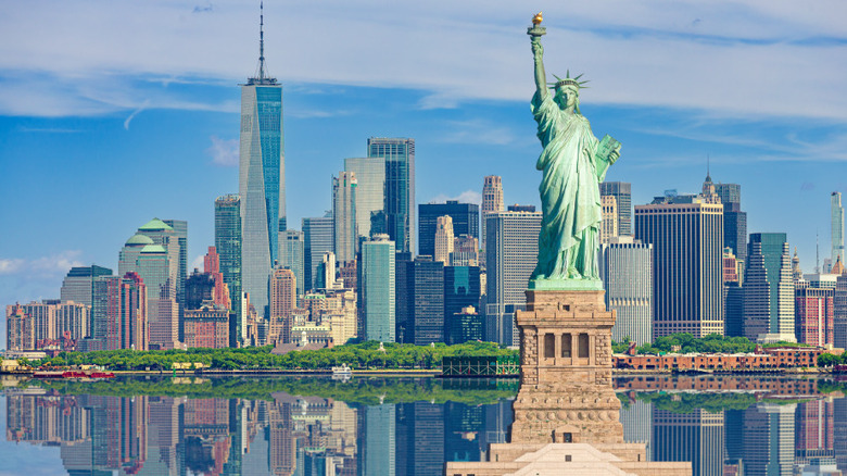 Lady Liberty in front of cityscape