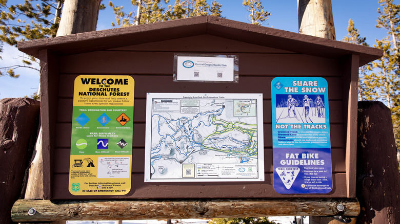 A trailhead marker with maps and signs in Oregon's Deschutes National Forest