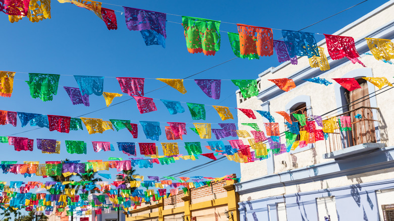 Festive colorful banners over a street in Todos Santos.