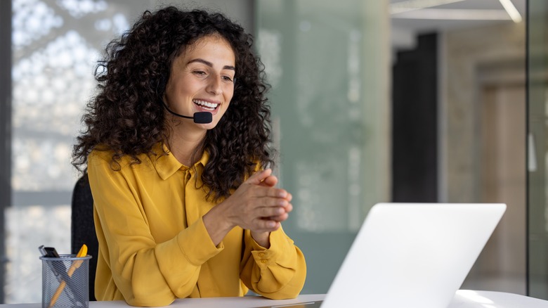 woman on call in front of laptop