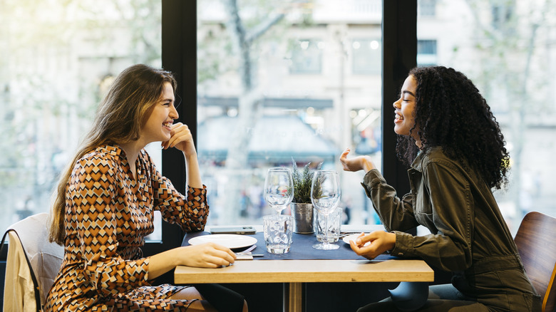 two happy women sitting at a restaurant