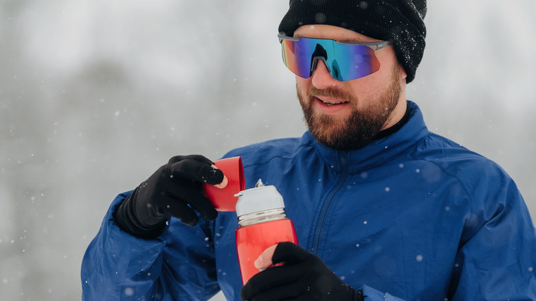 hiker with insulated beverage container