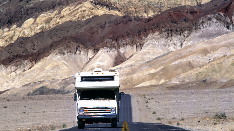 A camper driving on a highway in Death Valley California