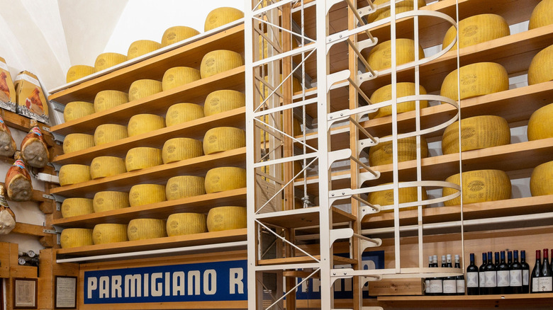 wheel of parmigiano reggiano cheese on shelves
