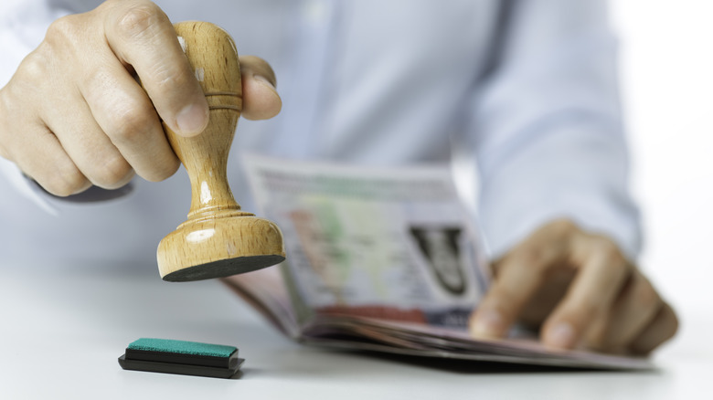 Person stamping a passport