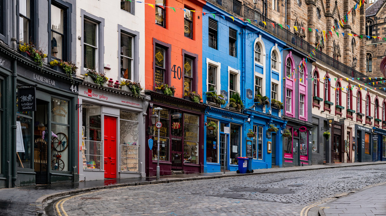 cobbled street alongside colorful Scottish buildings