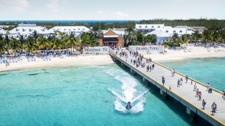 People stroll a boardwalk in Turks and Caicos