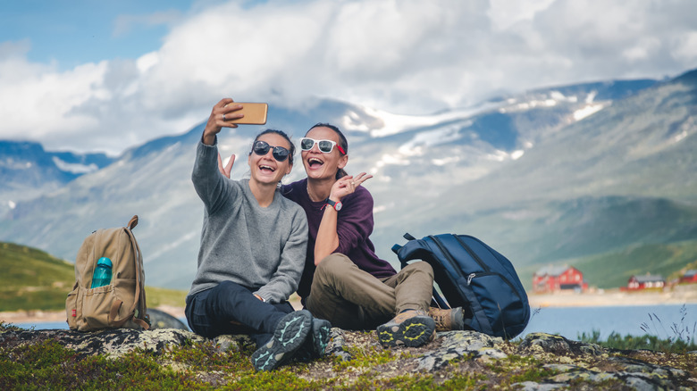 Two women taking a selfie on a mountain.