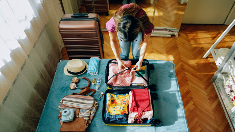 woman packing a suitcase
