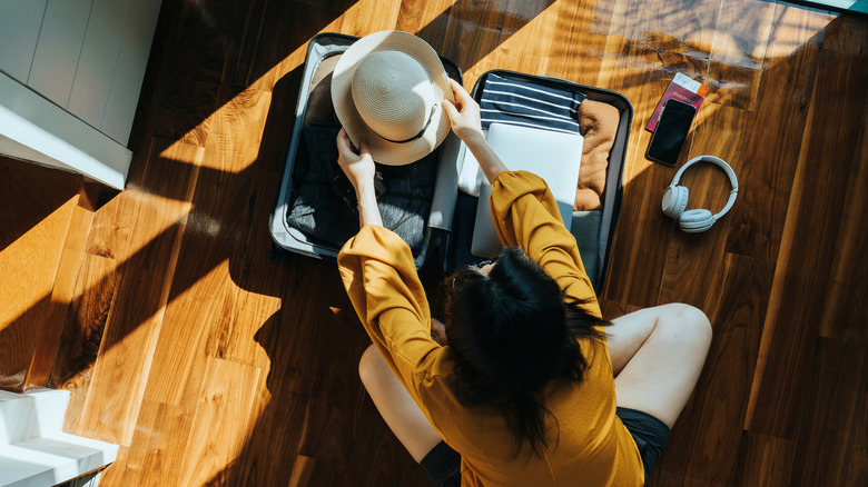View from above of a traveler packing their suitcase